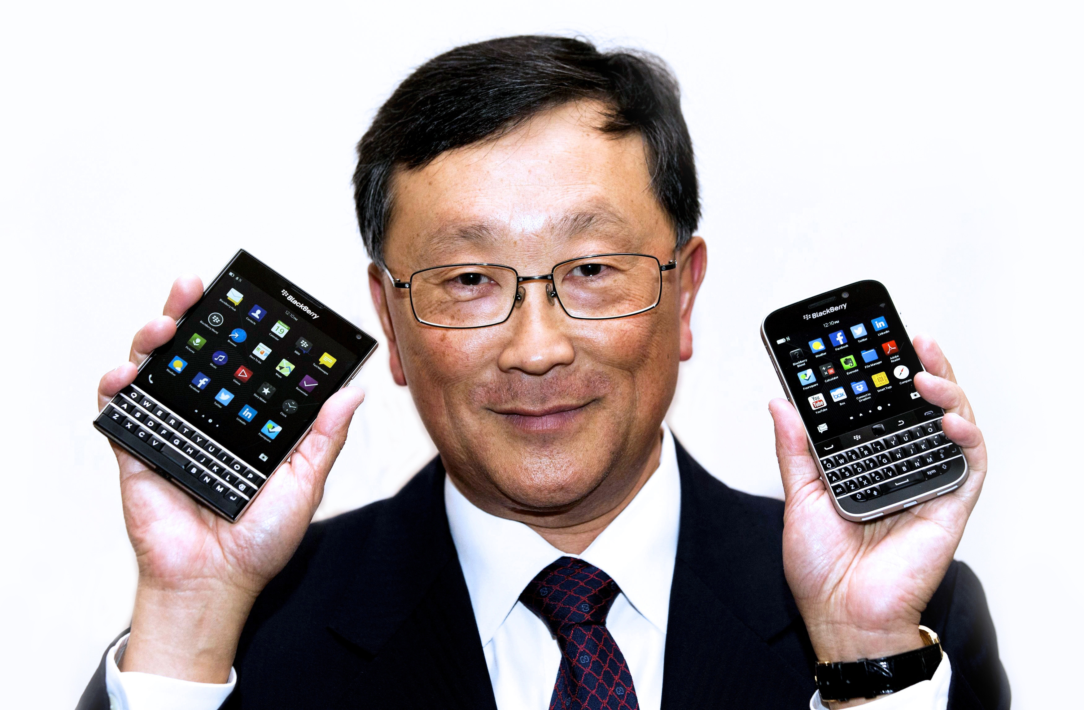 BlackBerry CEO Chen holds up the unreleased Blackberry Passport and Blackberry Classic devices during the company's annual general meeting for shareholders in Toronto