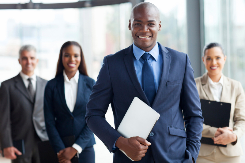 african businessman with group of businesspeople